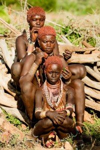 Women are doing their hair as part of their regular routine.